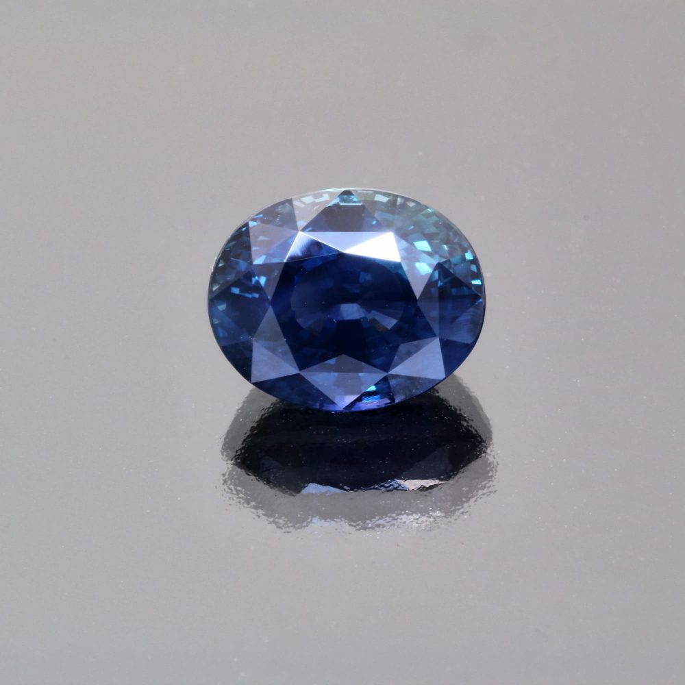 Indigo teal sapphire oval by Caram_front view