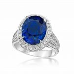 Sapphire oval ring with diamond triple shank by Caram